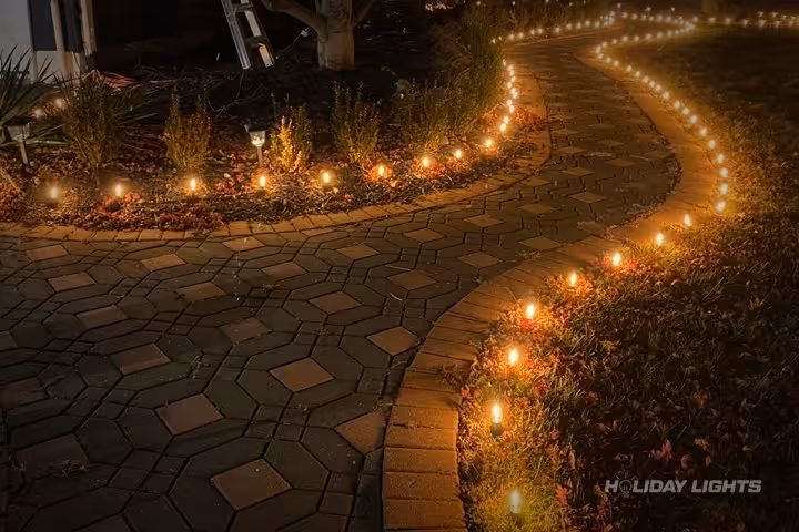 Warm white ground lights creating stunning pathway illumination for holiday displays Warm white ground lights creating stunning pathway illumination for holiday displays